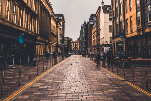 cobbled highstreet with high buildings either side